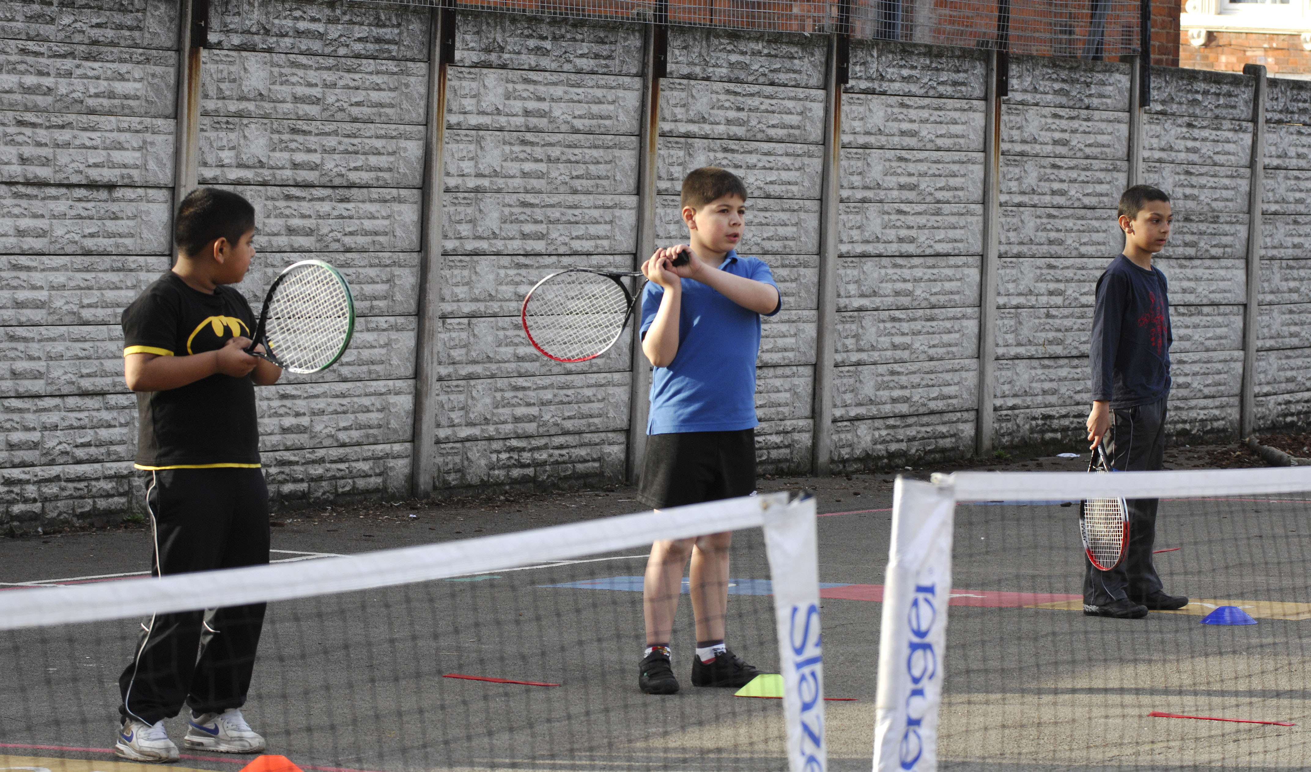 boys learning to play tennis